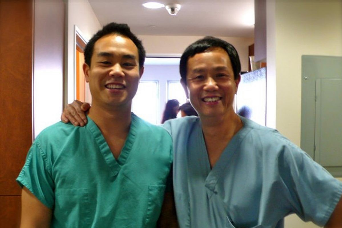dr. Michael chan with his father in scrubs smiling