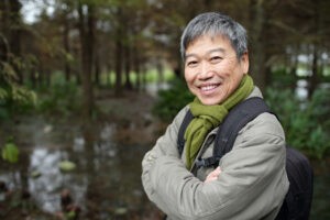 Older Asian Man Hiking in the Woods